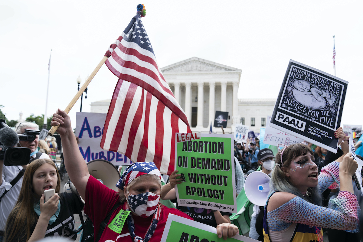 Signs from abortion rights and abortion opponents protesting, 6-24-22