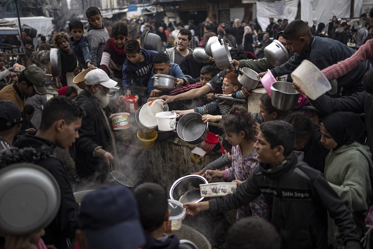 Palestinians line up for food in Rafah, Gaza, 12-21-2023