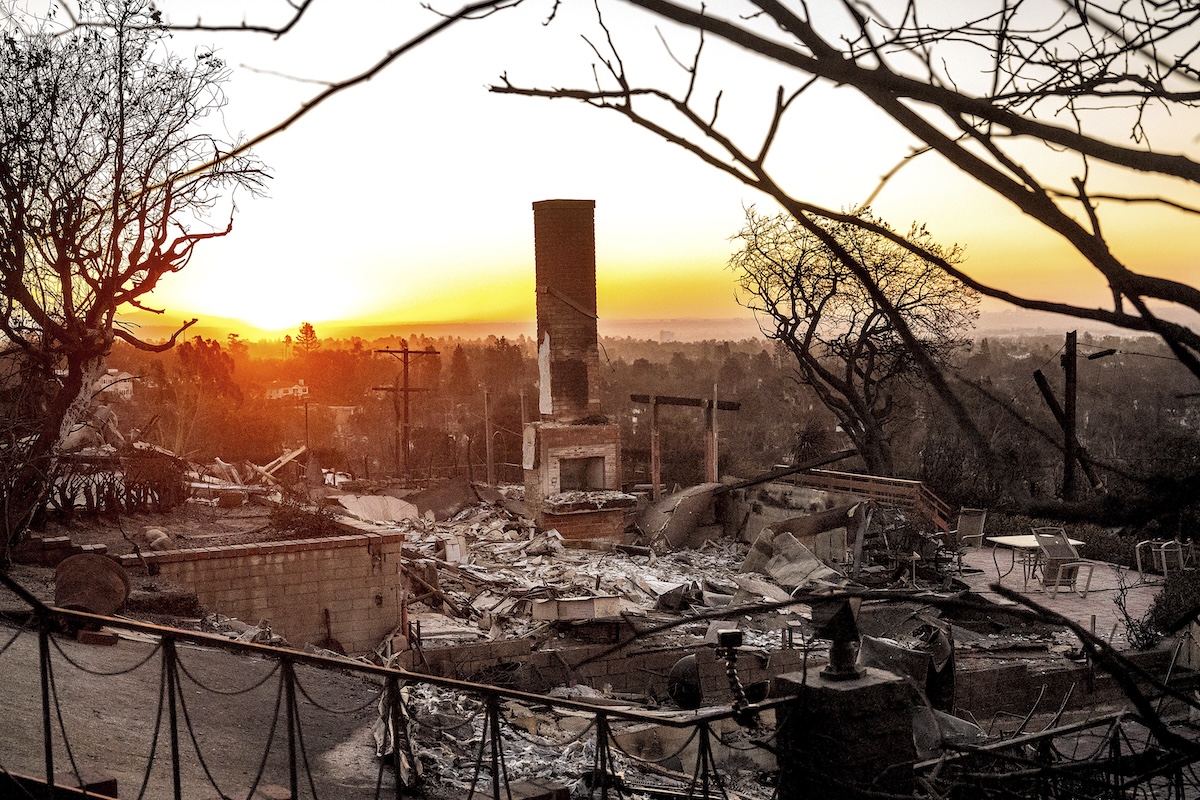 Sun rises behind Palisades neighborhood home destroyed by California wildfires, 1-12-2025