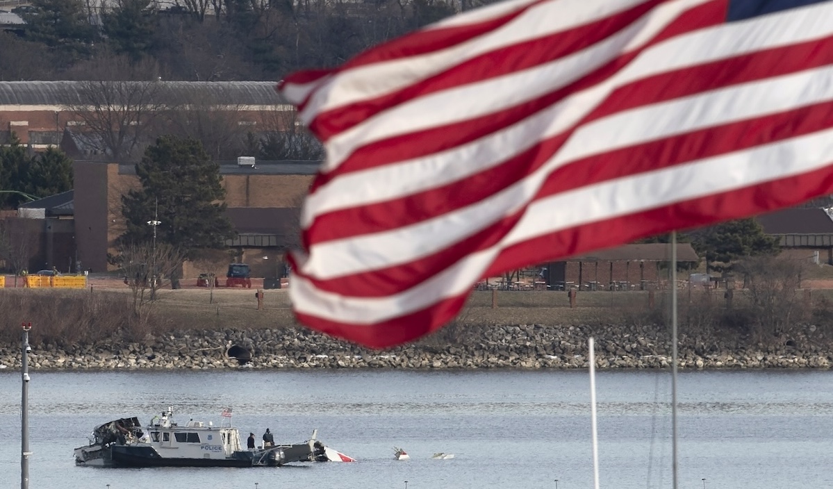 Plane crash at DCA with flag in foreground