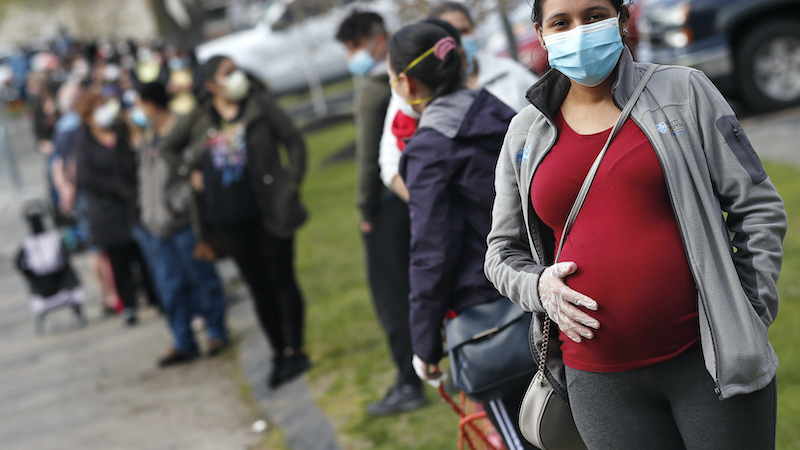 Pregnant woman with pandemic mask on art