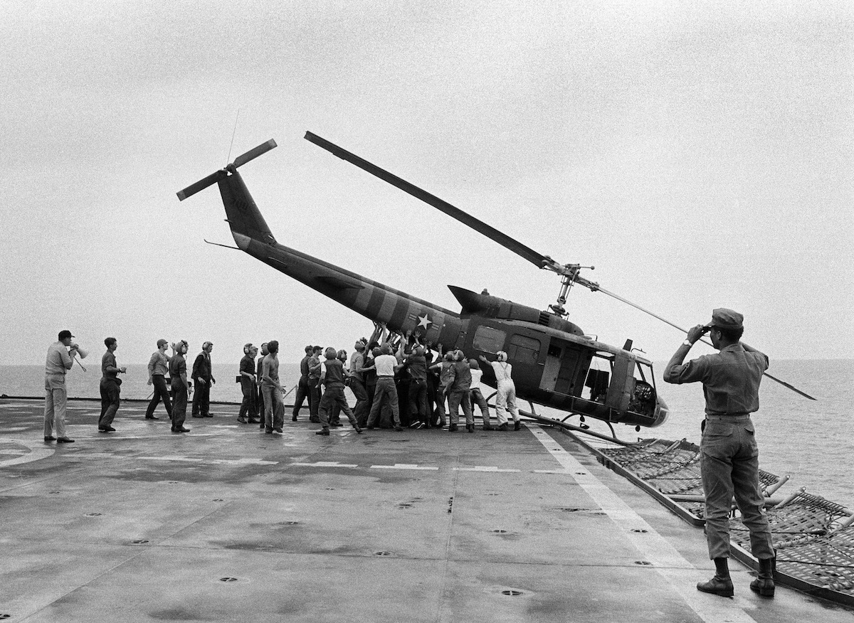 Saigon pushing helicopter off ship