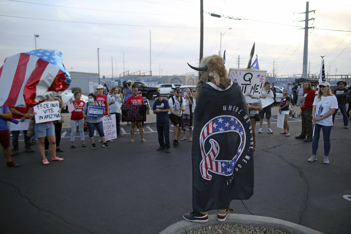 QAnon believer speaks speaks to a crowd at vote counting center in AZ Nov. 5, 2020