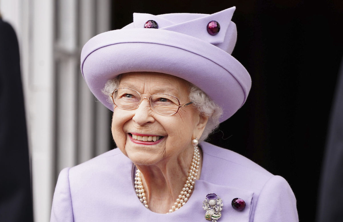 Queen Elizabeth smiling at a parade
