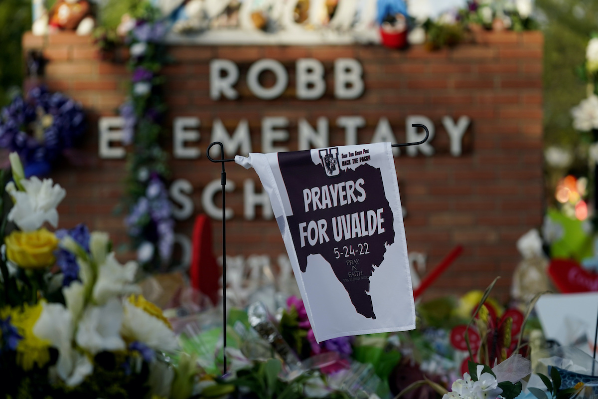 Uvalde shooting Robb Elementary School sign with flowers