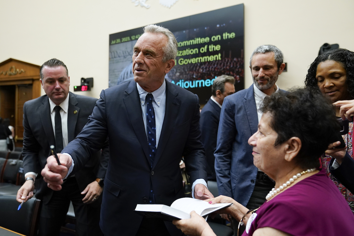 Robert F. Kennedy Jr. prepares to sign book after House testimony, 7-20-2023