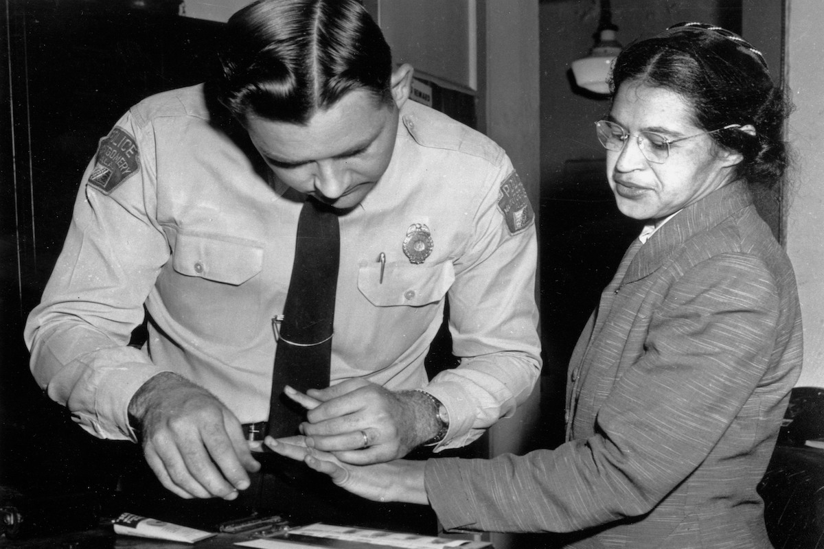 In this Feb. 22, 1956, file photo, Rosa Parks is fingerprinted by police Lt. D.H. Lackey in Montgomery, Ala., two months after refusing to give up her seat on a bus for a white passenger on Dec. 1, 1955. She was arrested with several others who violated s
