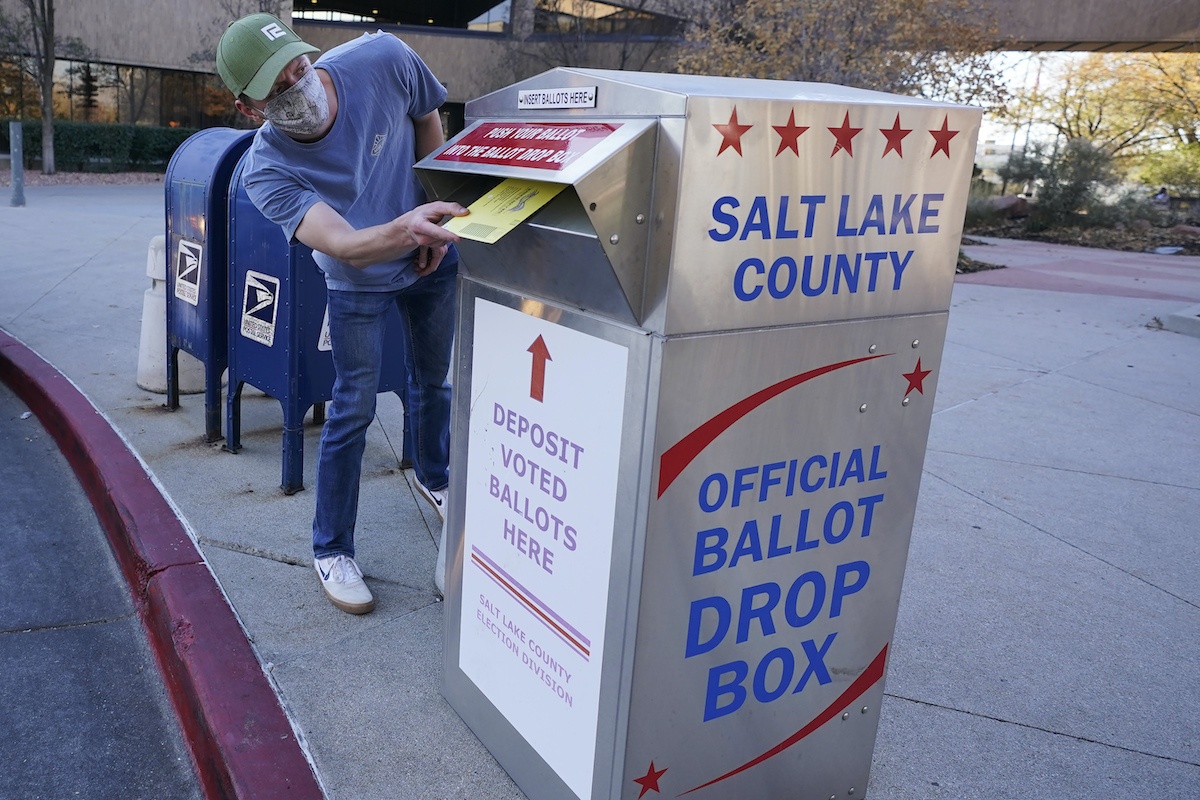 Masked voter uses ballot drop box in Salt Lake City 11-2-20