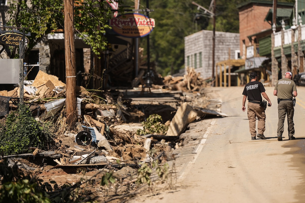 Sheriff deputies walk in Chimney Rock Village, N.C. after Hurricane Helene 10-02-2024