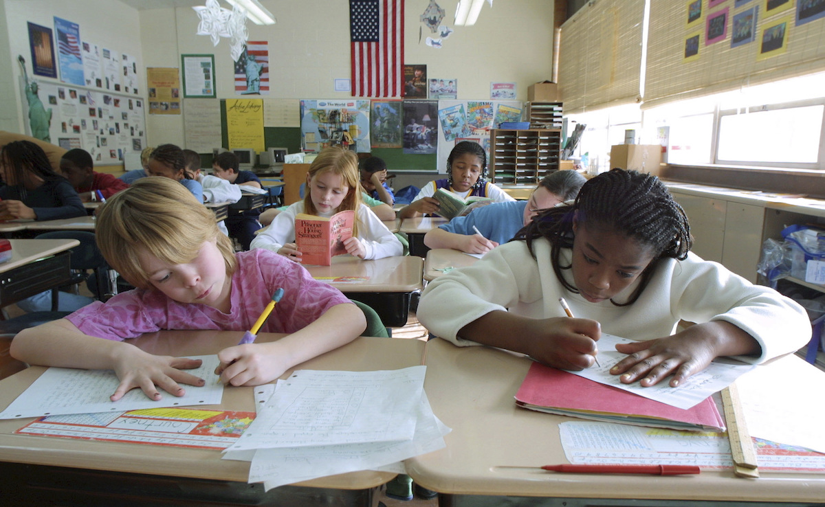 Students write essays in Michigan classoom, older photo