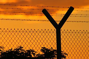 Border fence at sunset