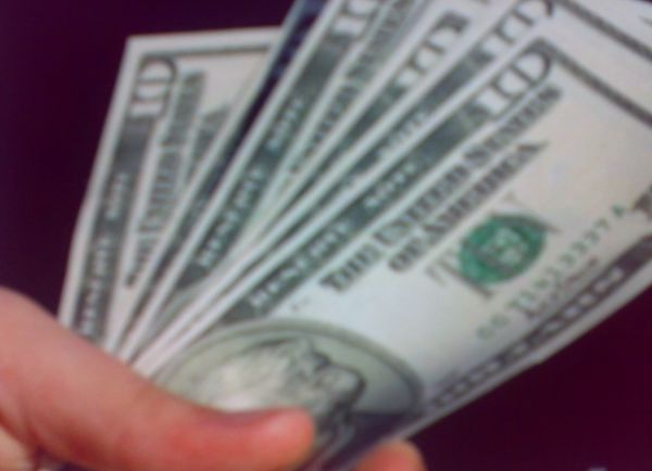 Ten dollar bills in hand
