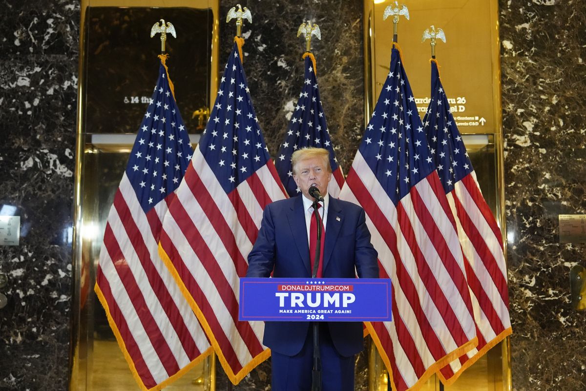 Trump at Trump tower with flags