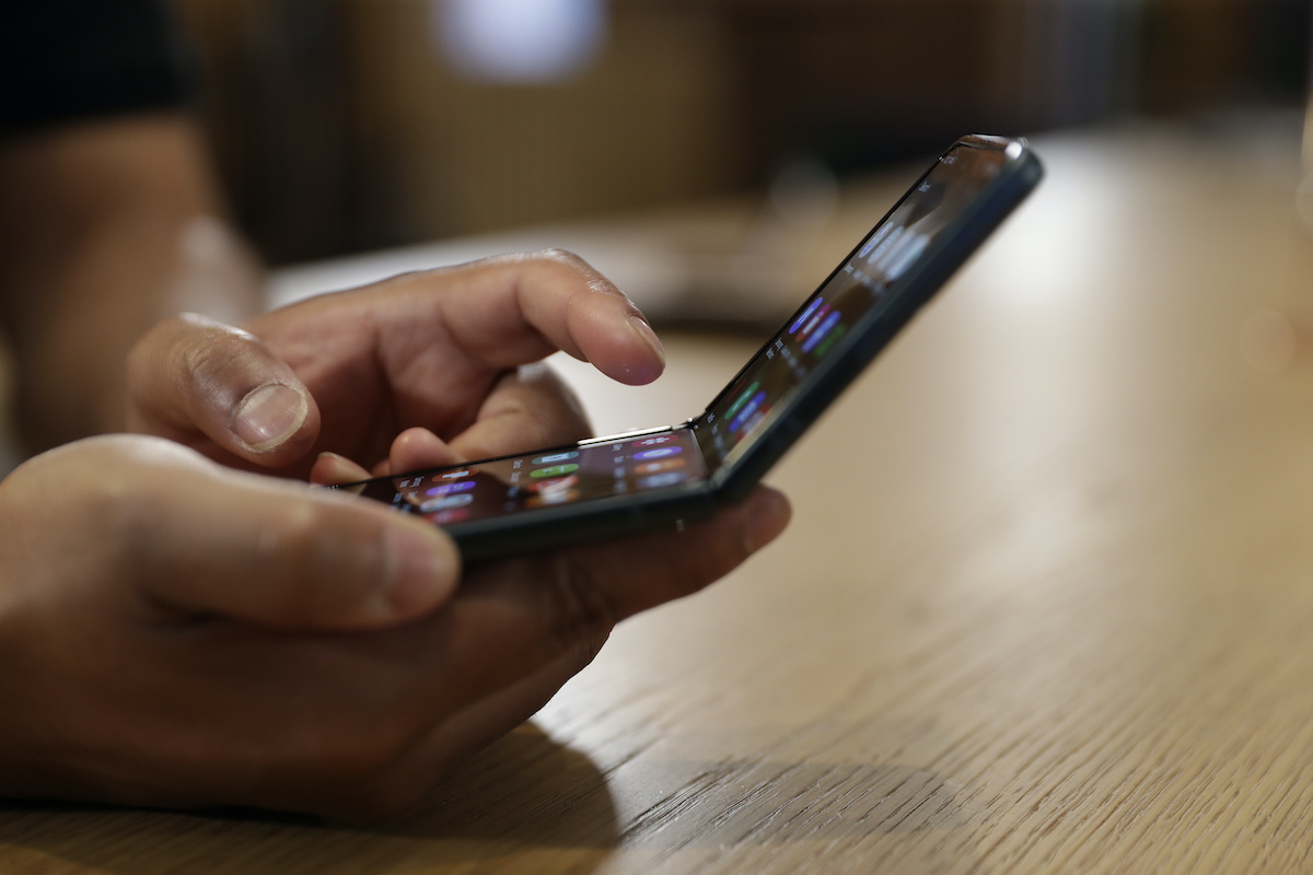 Person using foldable smartphone