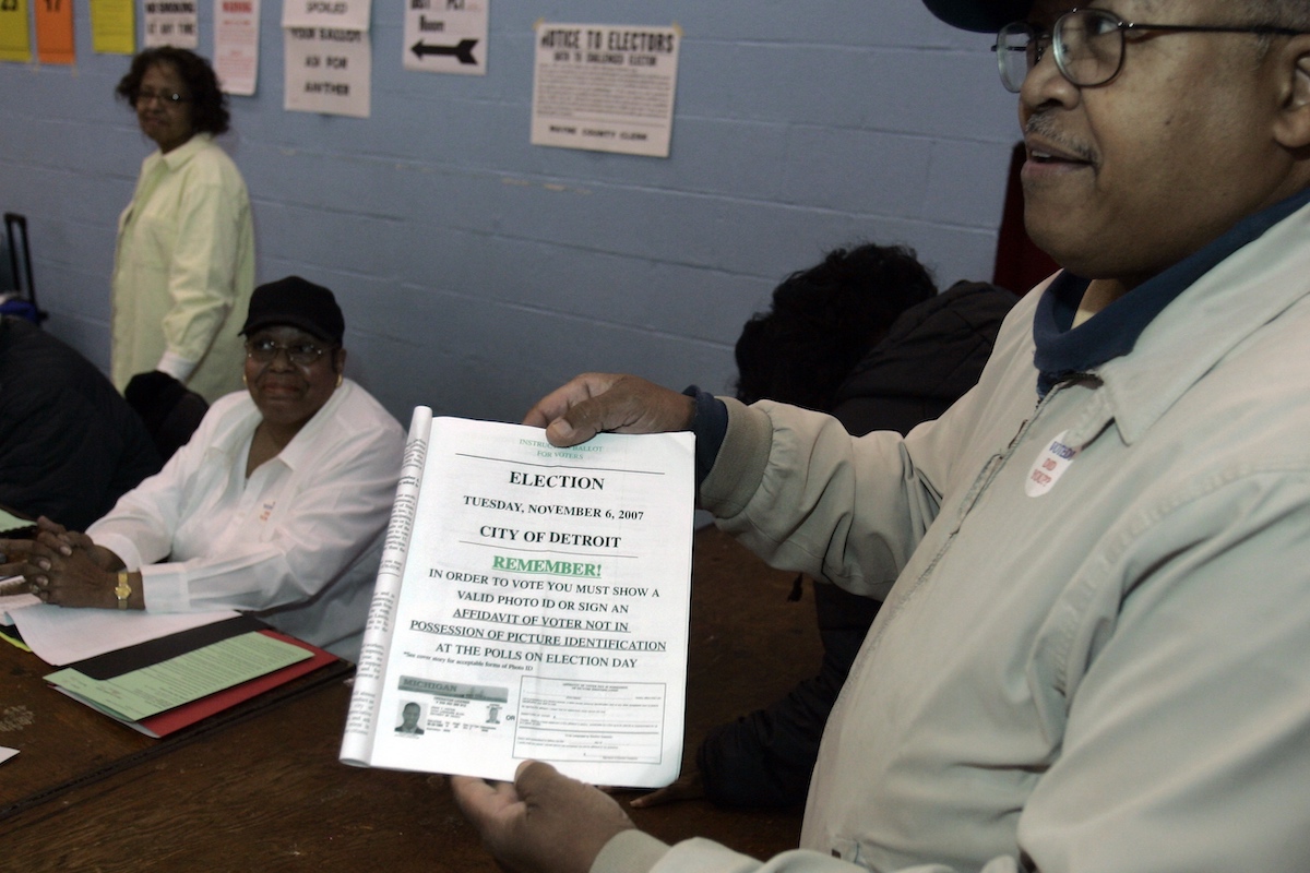 Voter shows Detroit mailer reminder voters they need a photo ID