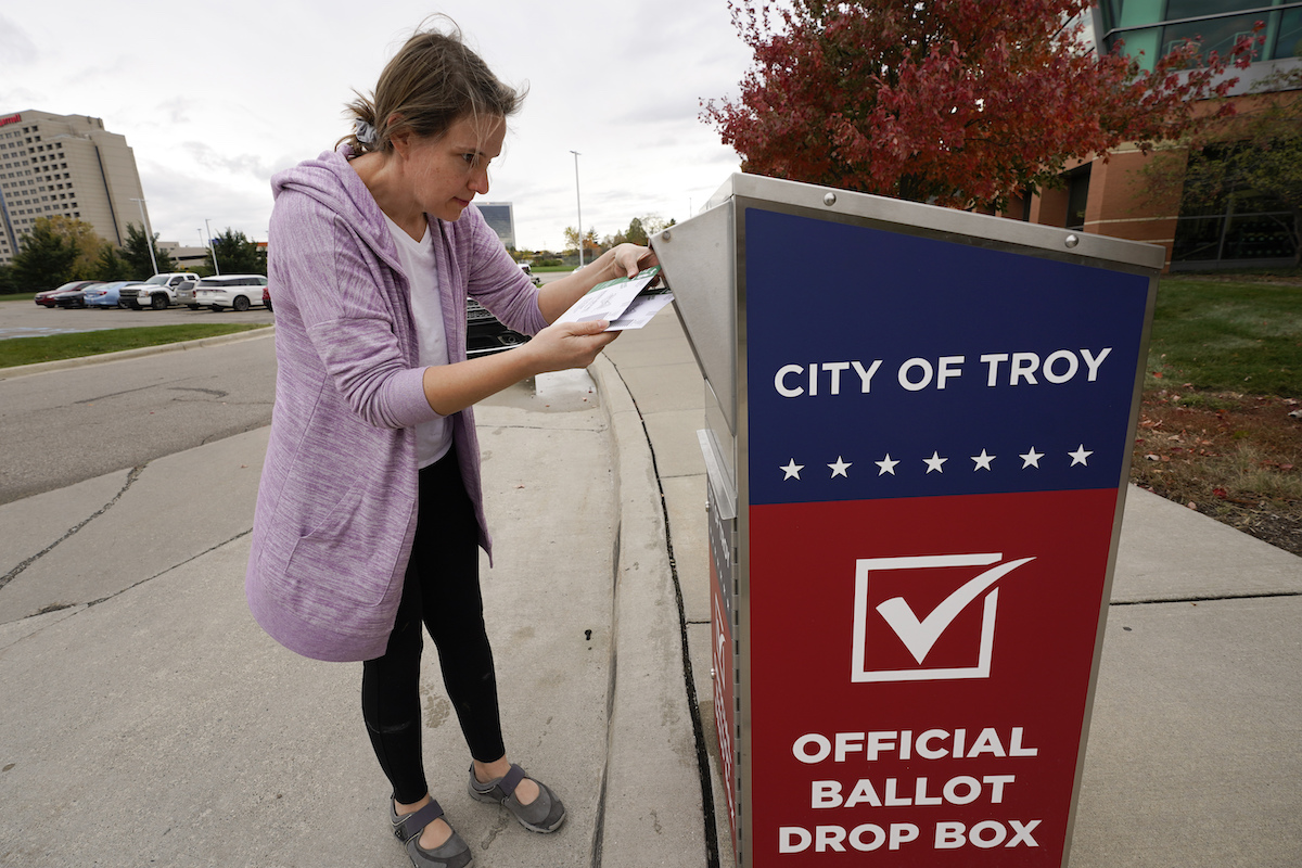 Voter uses ballot drop box in Troy, Mich. Oct. 2020