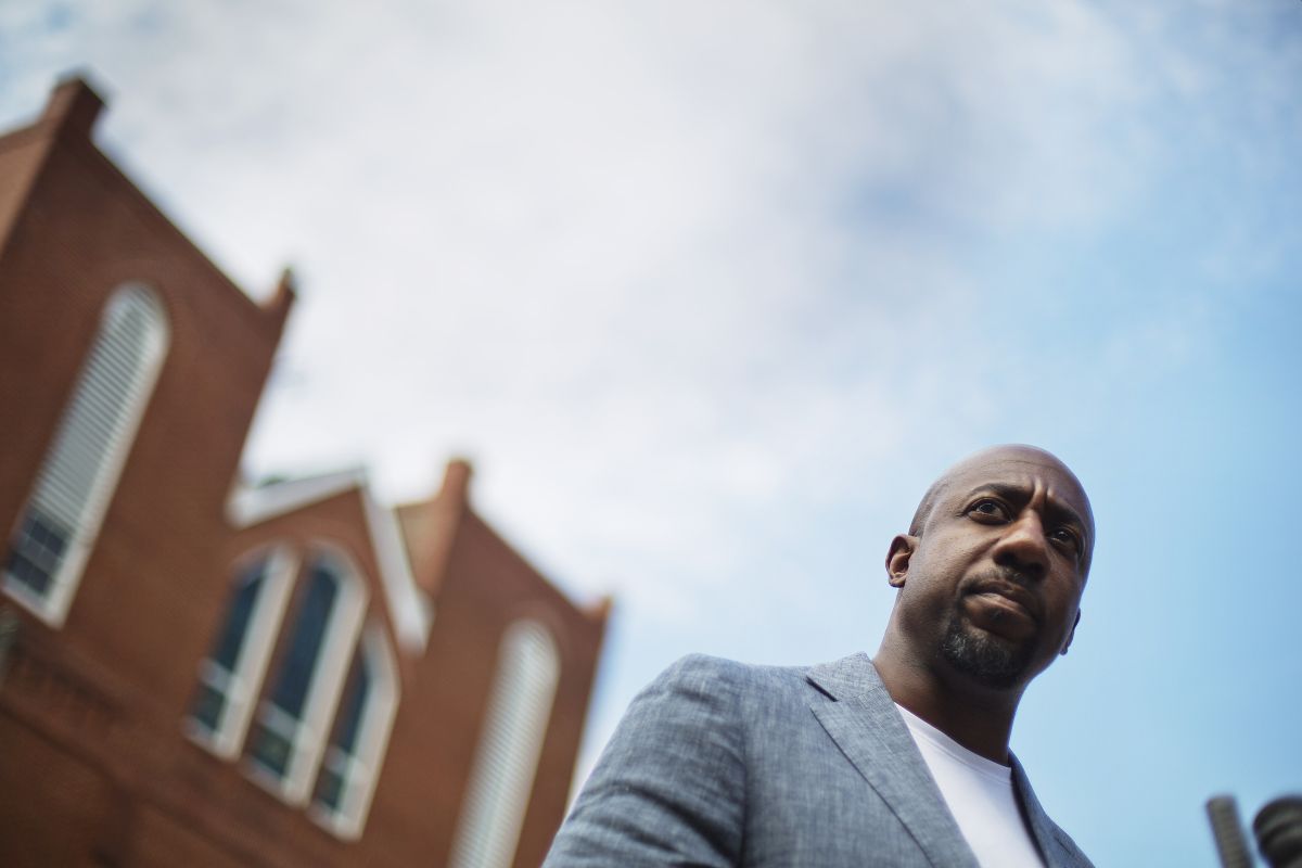 Warnock in front of church