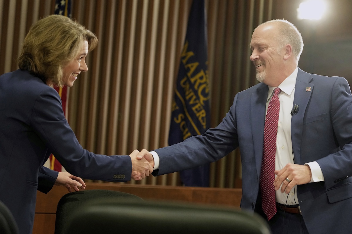 Brad Schimel and Susan Crawford shake hands 3/12/2025