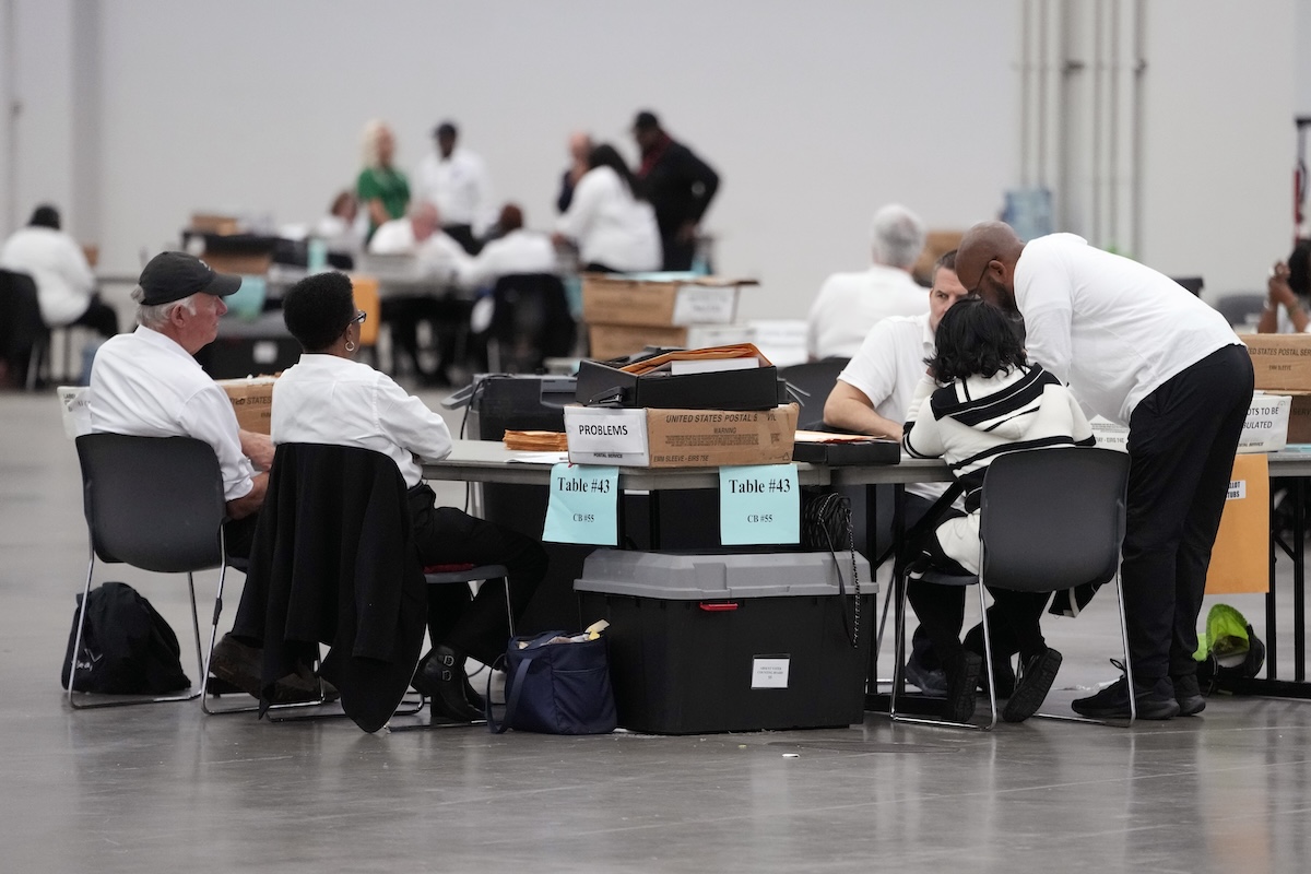 Workers tabulate absentee ballots in Detroit, 10-31-2024