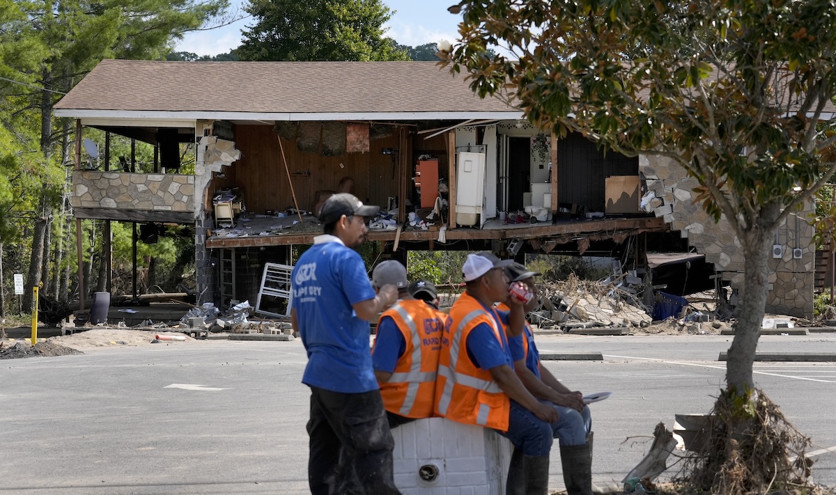 Workers take break during Hurricane Helene cleanup in Newport, TN, Oct. 5, 2024
