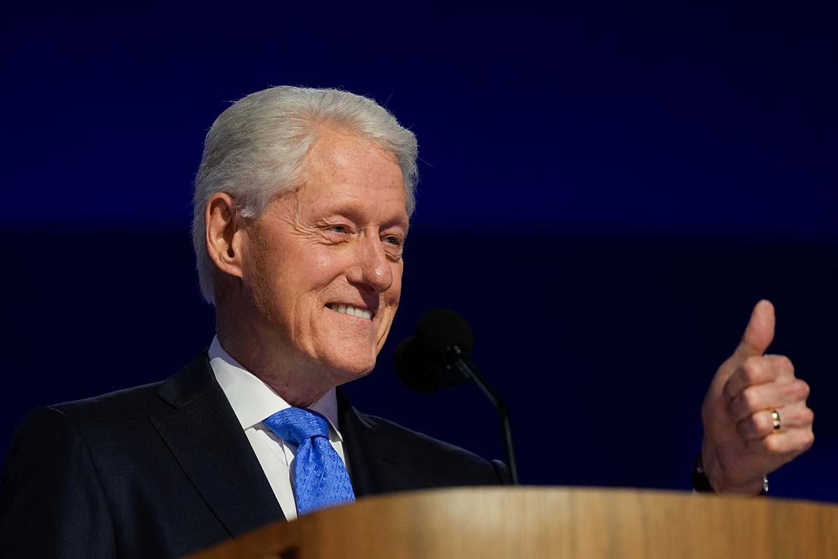 Former President Bill Clinton gives a thumbs up behind the lectern at the DNC in Chicago, 8-21-2024