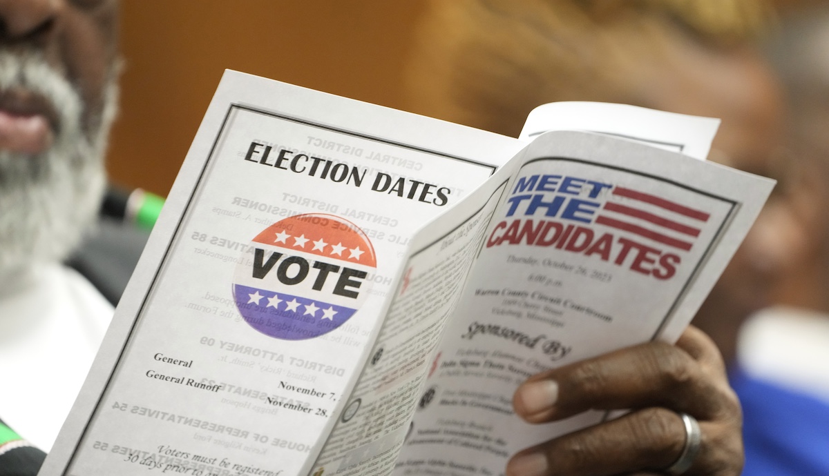 A candidates forum attendee reviews the event program in Vicksburg, Miss., 10-26-2023