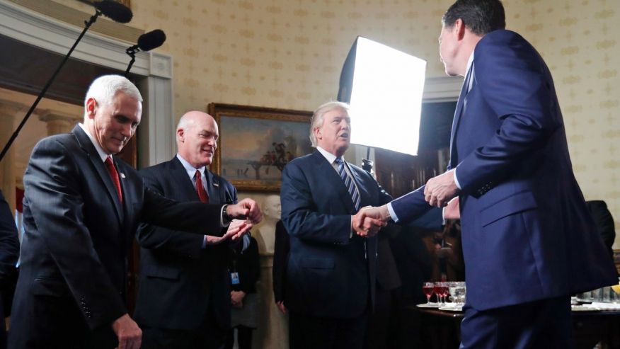 Comey shaking hands with trump