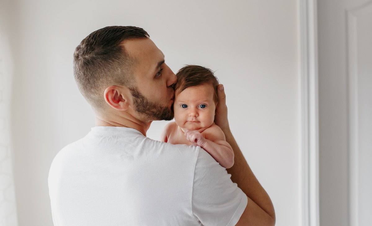 Shutterstock image of new dad and baby daughter from for check on COVID-19 and male fertility, 1-26-2024