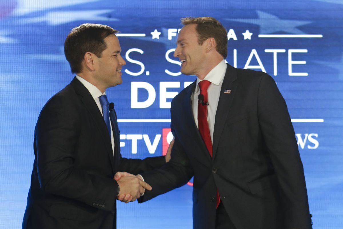 Marco and Patrick handshake at debate