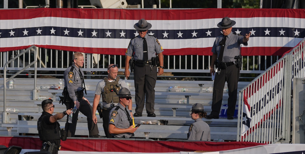 Police gather onstage after shooting at Donald Trump campaign rally in Butler, Pa., 7-13-2024