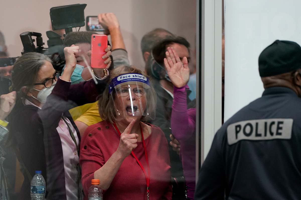 Poll challengers crowd a space in Detroit, 11-4-2020