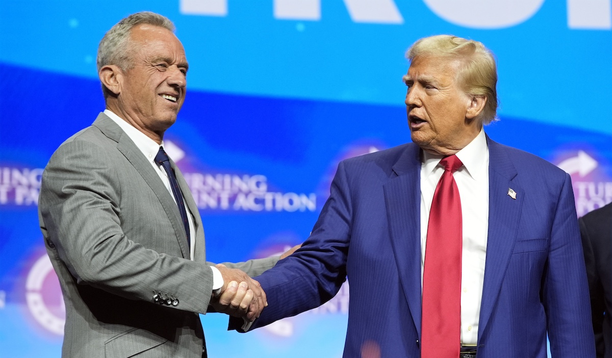 President-elect Donald Trump and Robert F. Kennedy Jr. shake hands at a Turning Point Action campaign rally in Duluth, Ga., 10-23-2024