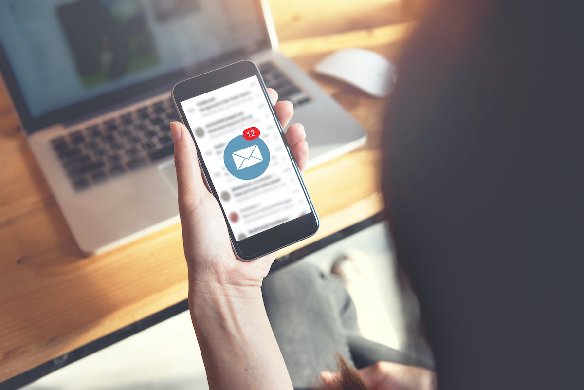 stock image of woman receiving email on her phone