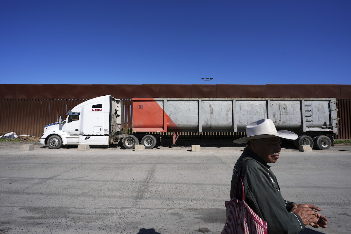 Peanut seller Susano Cordoba at the southern border with trucks