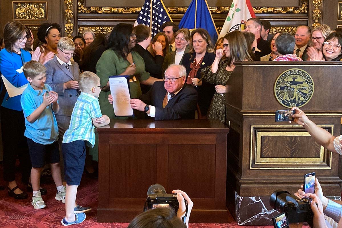 Minnesota Gov. Tim Walz signed family leave bill in St,. Paul, Minn., 5-25-2023