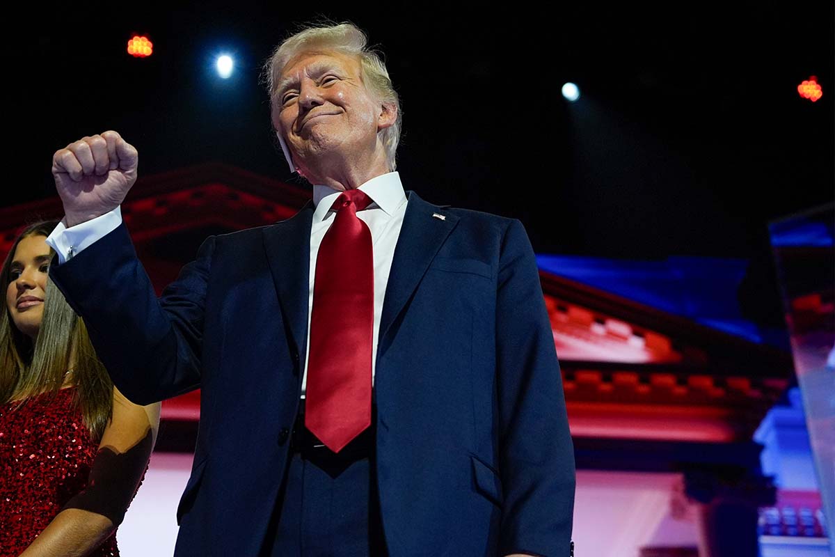 Donald Trump raised fist, red tie, RNC in Milwaukee, 7-18-2024