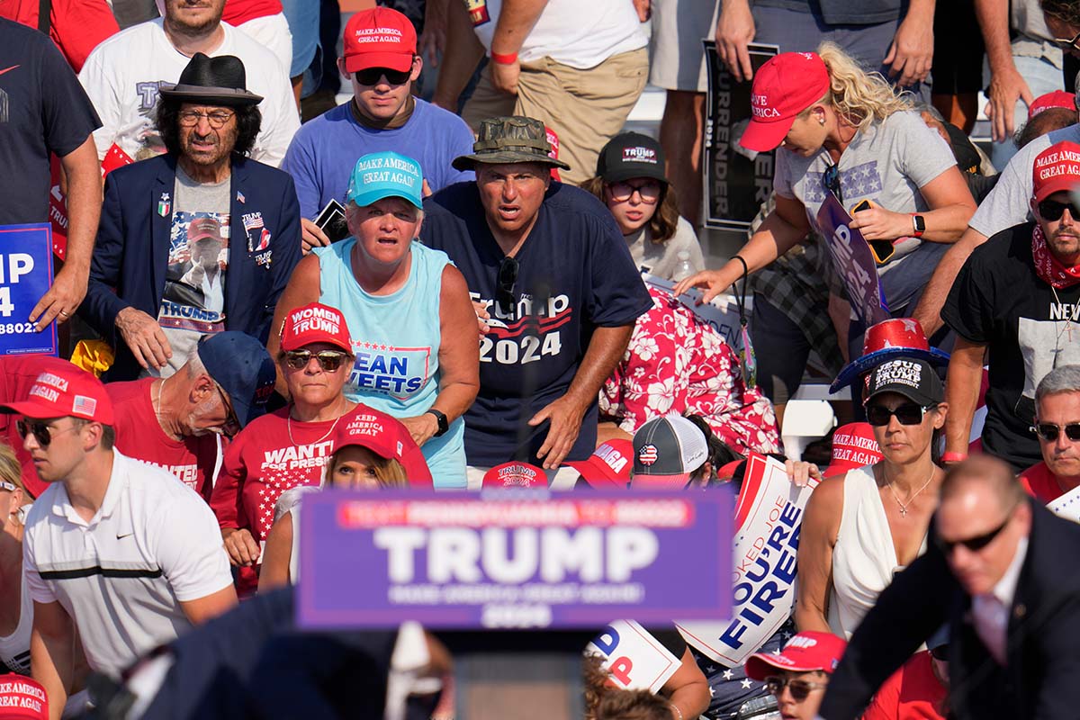 Rallygoers behind Trump lectern at campaign rally in Butler, Pa., 7-13-2024