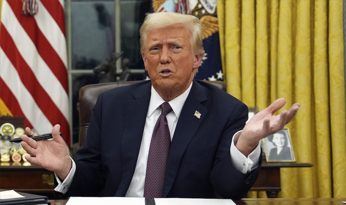 Donald Trump signs executive orders in the Oval Office, 1-20-2025