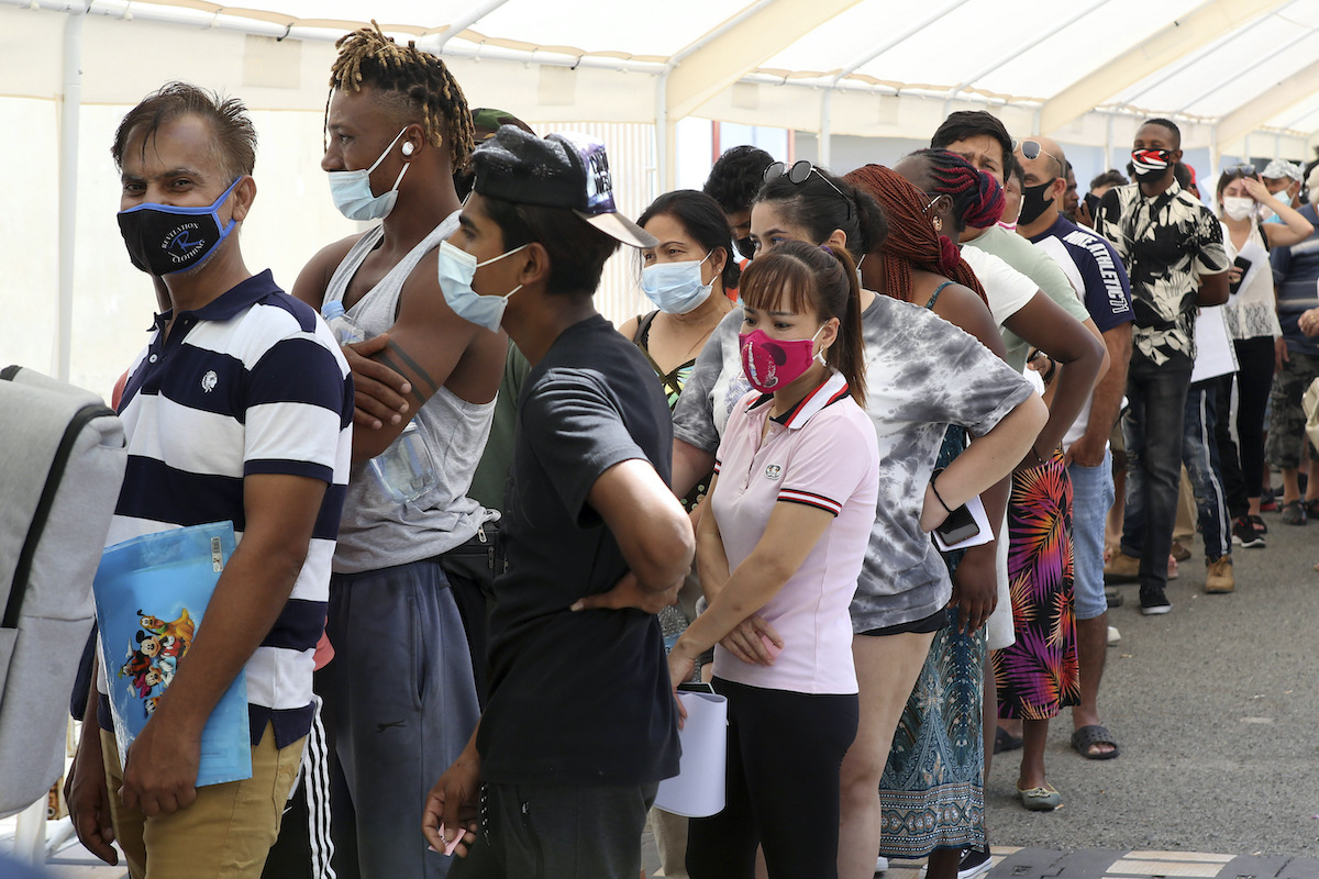 People wait in line to receive a COVID-19 vaccine shot at Cyprus' State Fair in Nicosia, Cyprus, Aug. 13, 2021. (AP)
