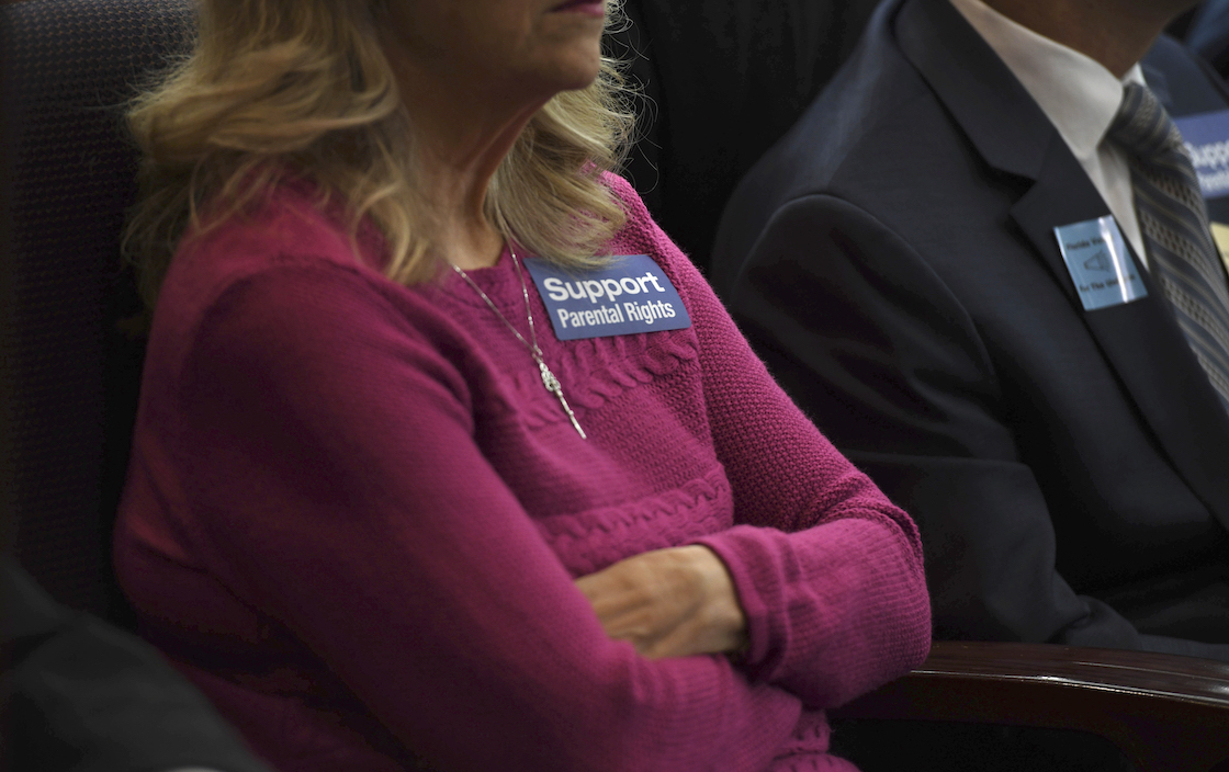 Woman sits with parental rights sticker in Florida in 2020