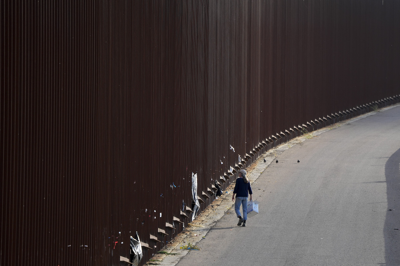 person walking along the wall May 2023