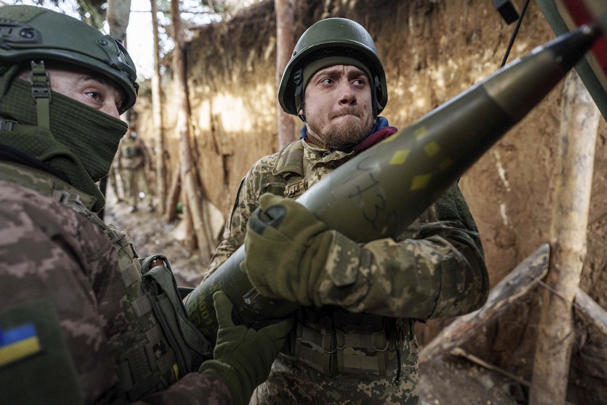 Ukrainian soldiers holding weapon, Jan. 2024