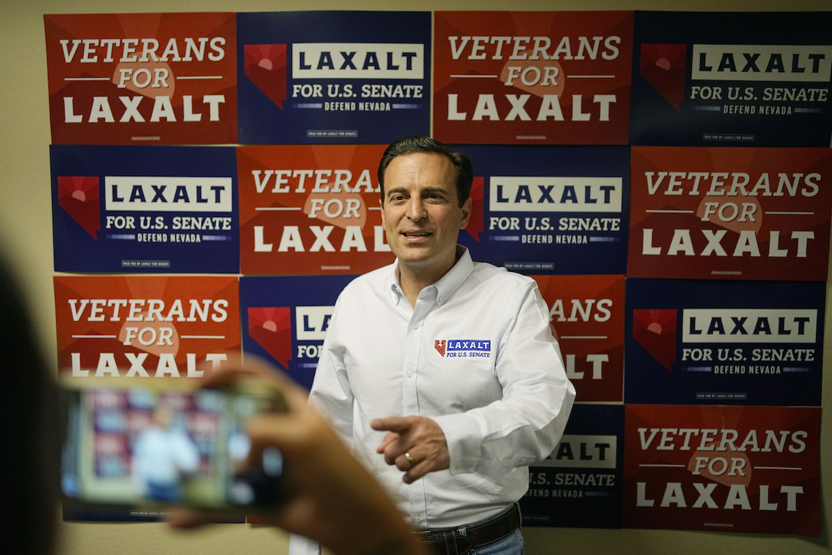 Adam Laxalt in front of flyers at campaign event