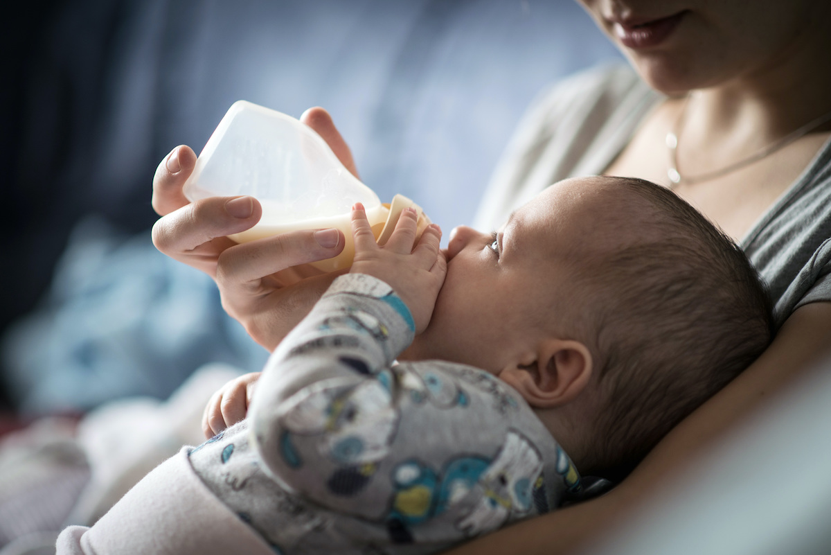 Baby feeding from bottle - shutterstock