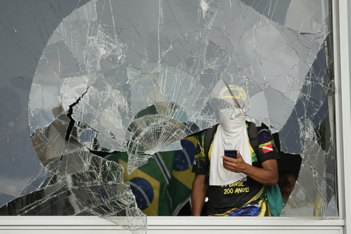 Bolsonaro supporter in breached building/broken glass, Jan. 8 2023