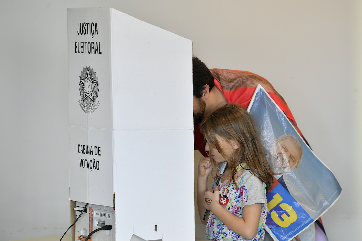 Man in Brazil votes next to girl 10-30-22