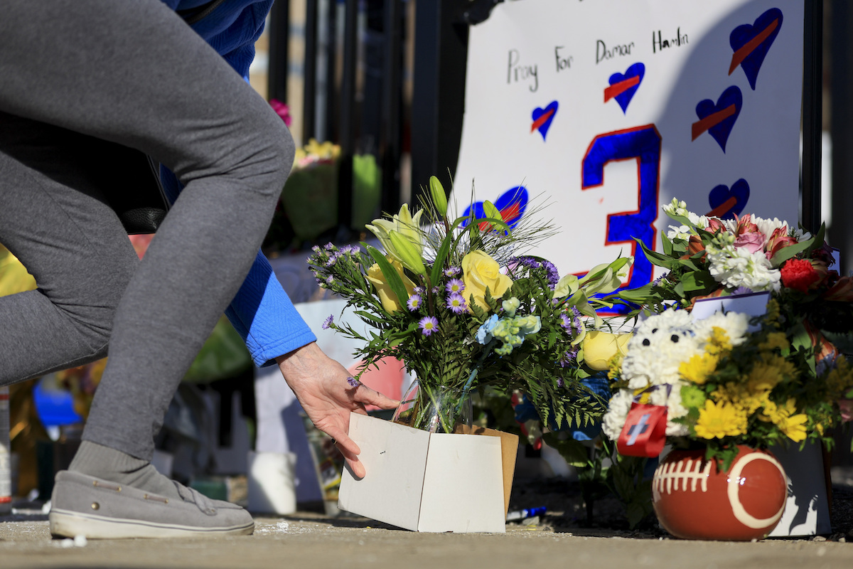 Person leaves flowers for Damar Hamlin outside Cincinnati hospital Jan. 4, 2023