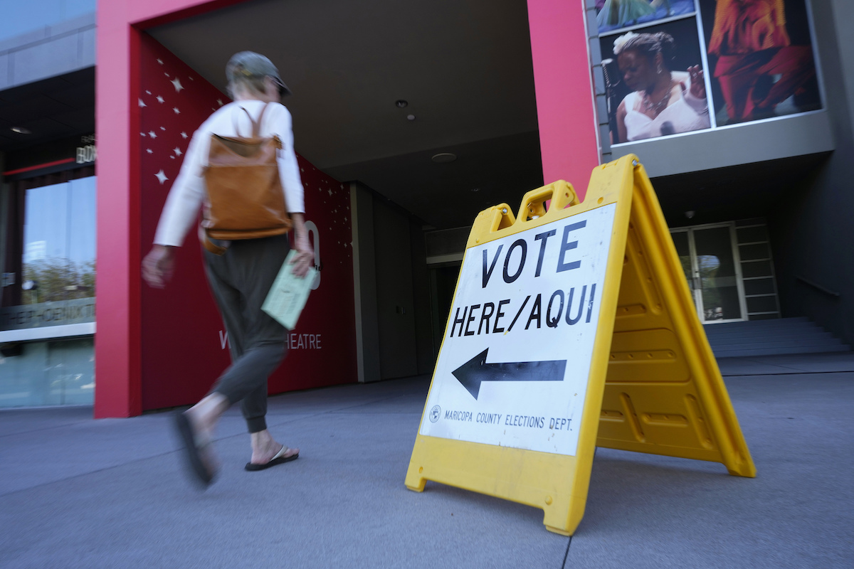 Phoenix voter with vote center sign 2022