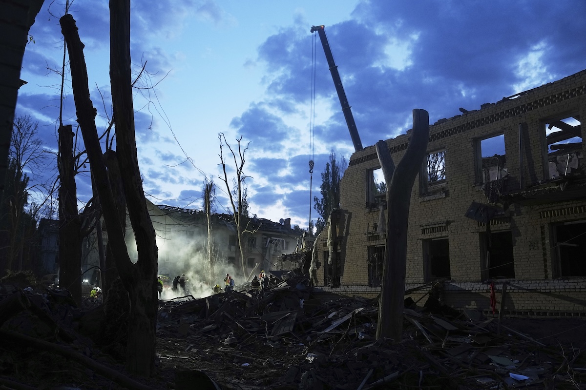 Rescue workers clear rubble after Russian missile attack in Kyiv, Ukraine, 4-24-2025