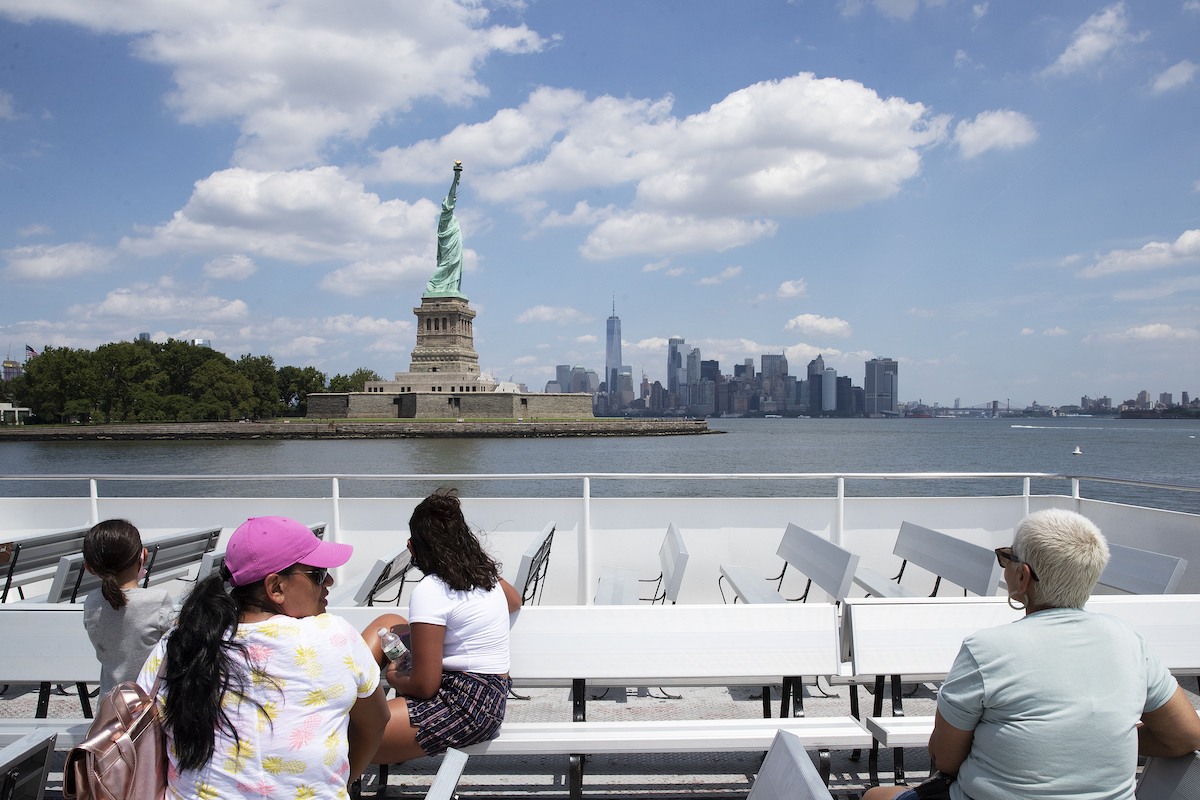 Statue of Liberty from boat with visitors